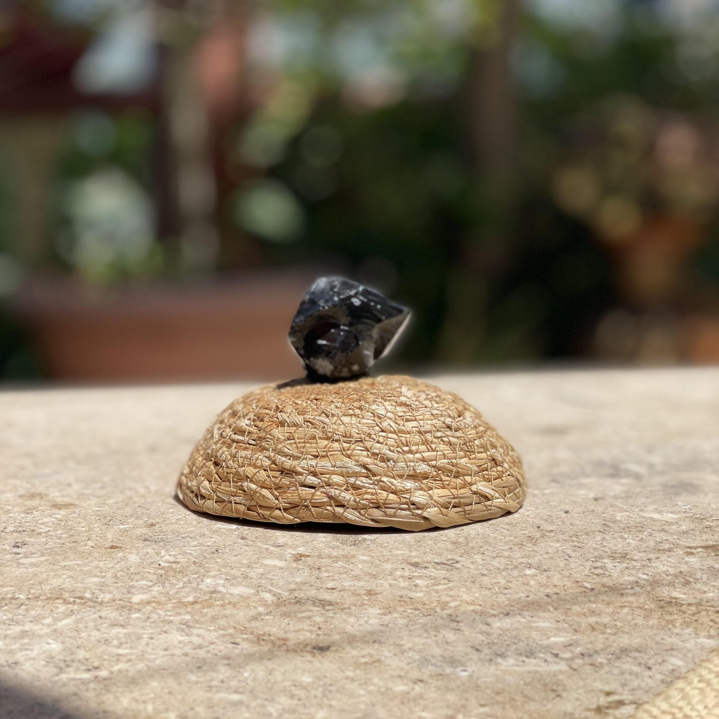 Raw Snowflake Obsidian balance stone in a protective glass dome for calm energy and nature-inspired meditation.