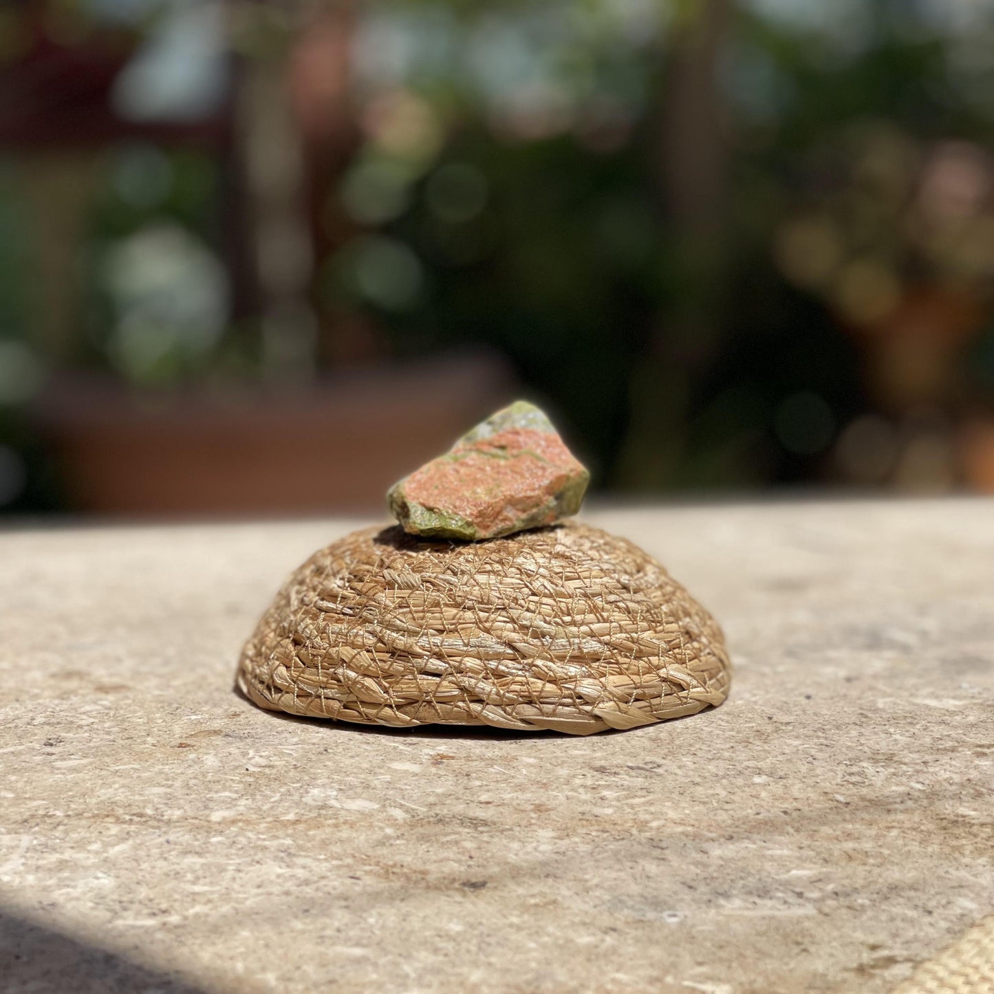Raw Unakite balance stone in a protective glass dome for emotional healing and nature-inspired meditation.