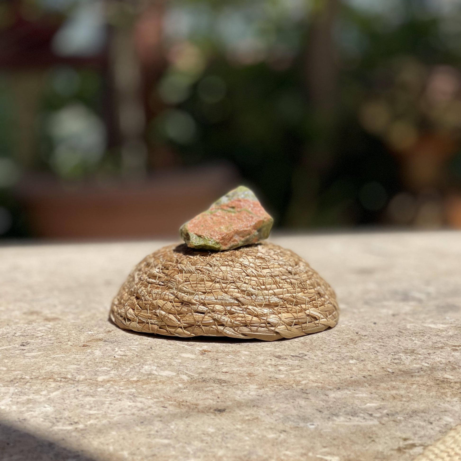 Raw Unakite balance stone in a protective glass dome for emotional healing and nature-inspired meditation.
